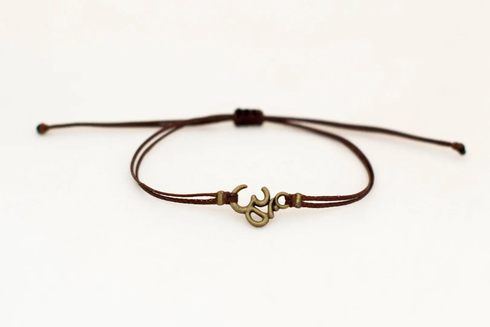 Men's bracelet with bronze Om charm, brown cord