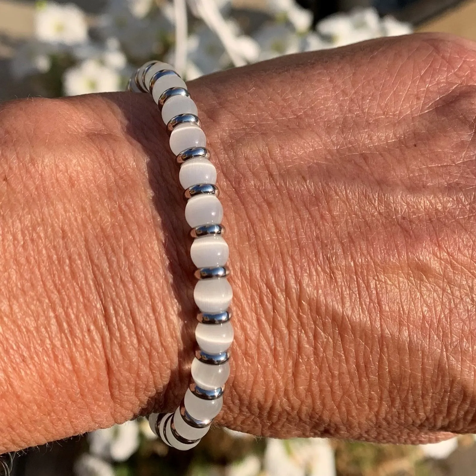 White cat's eye bracelet against the evil eye