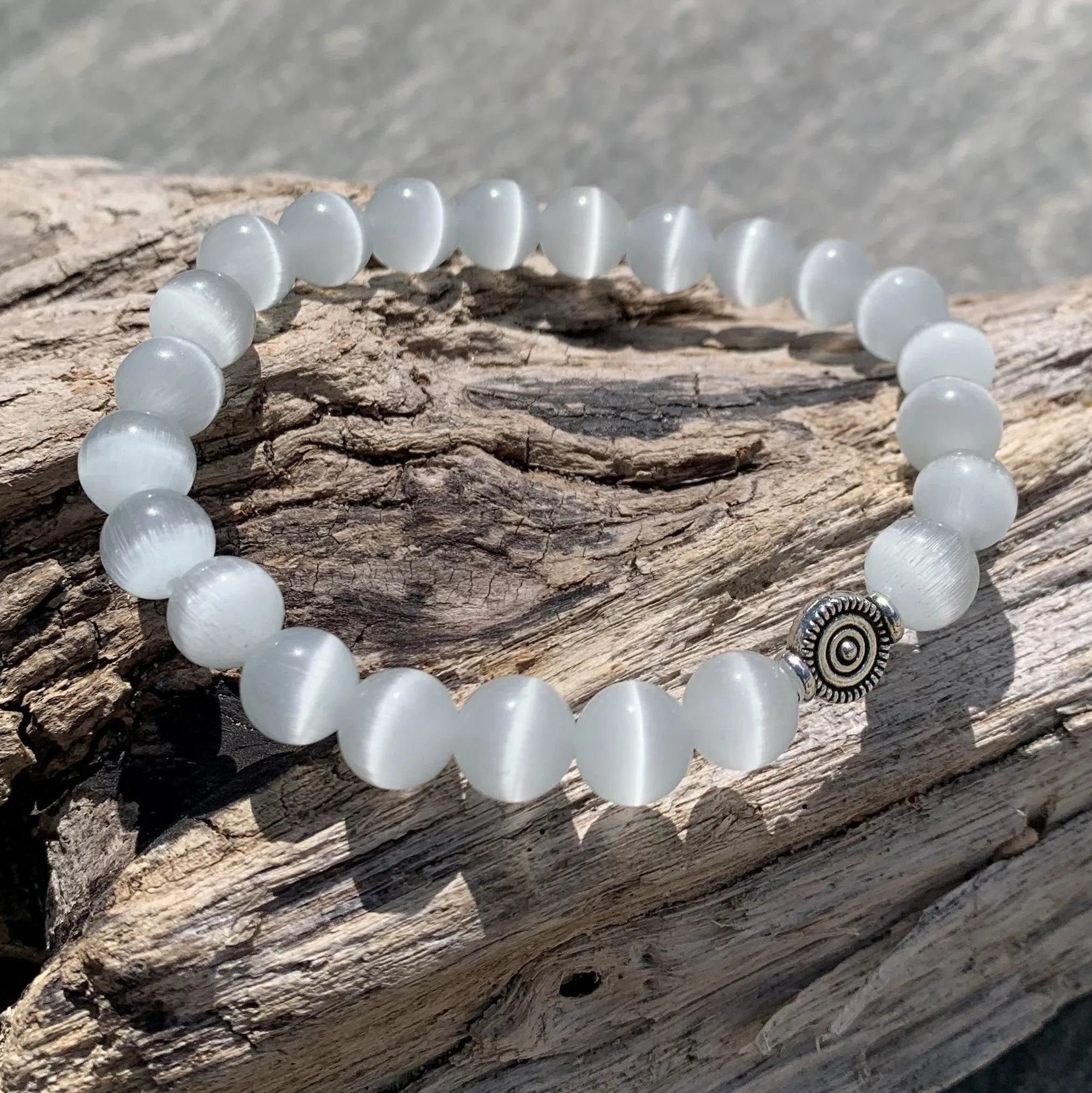 White cat's eye bracelet against the evil eye