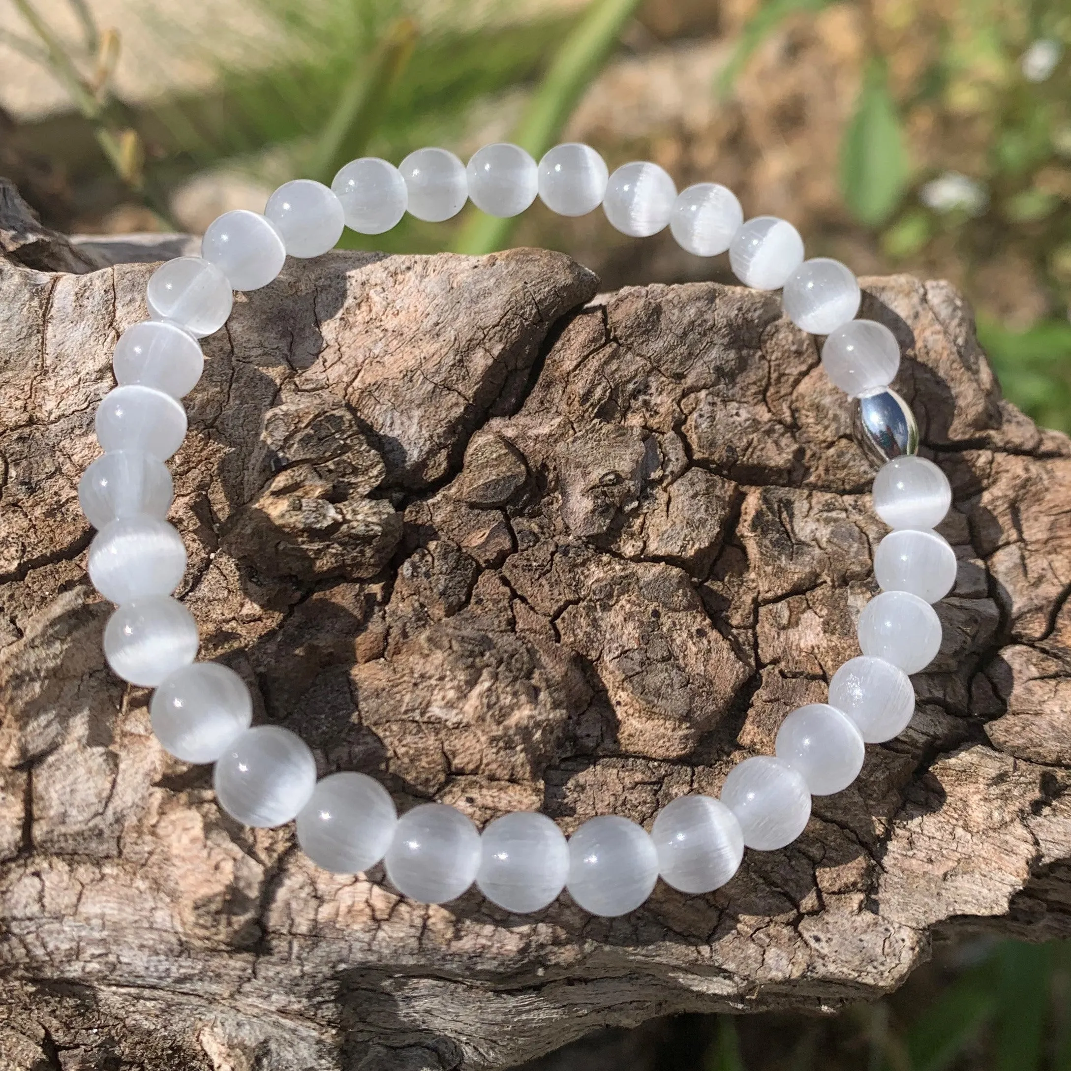 White cat's eye bracelet against the evil eye