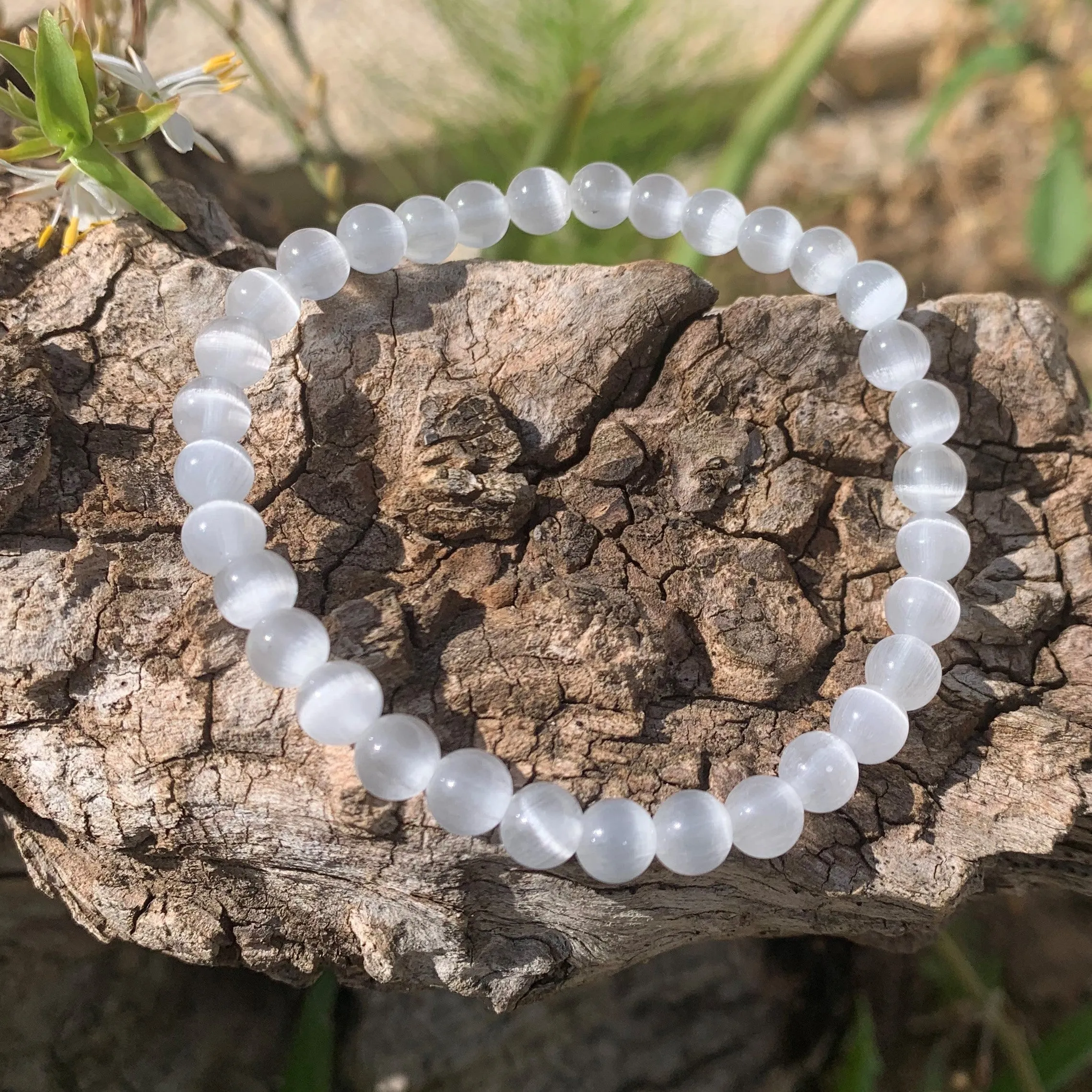 White cat's eye bracelet against the evil eye